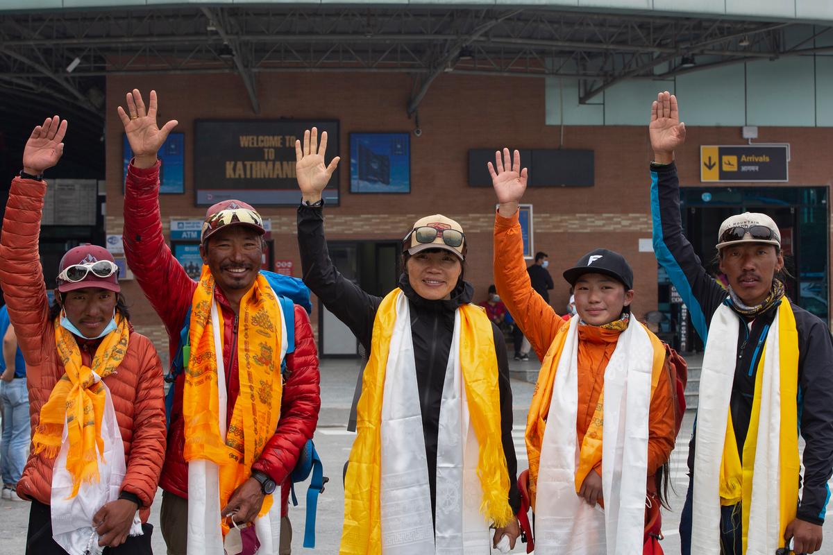 Tsang Yin-hung, 45, center, of Hong Kong scaled Mount Everest from the base camp in 25 hours and 50 minutes, and became the mountain's fastest female climber. (Bikram Rai/AP Photo)
