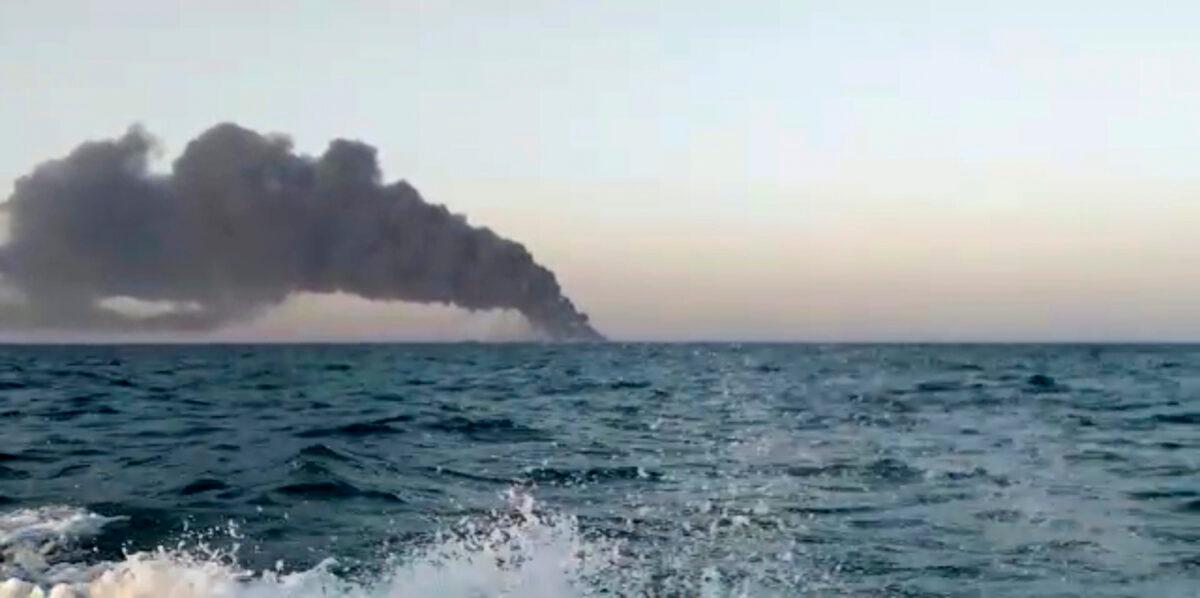 This image made from a video shows smoke rising from Iran's navy support ship Kharg in the Gulf of Oman, on June 2, 2021. (Asriran.com via AP)