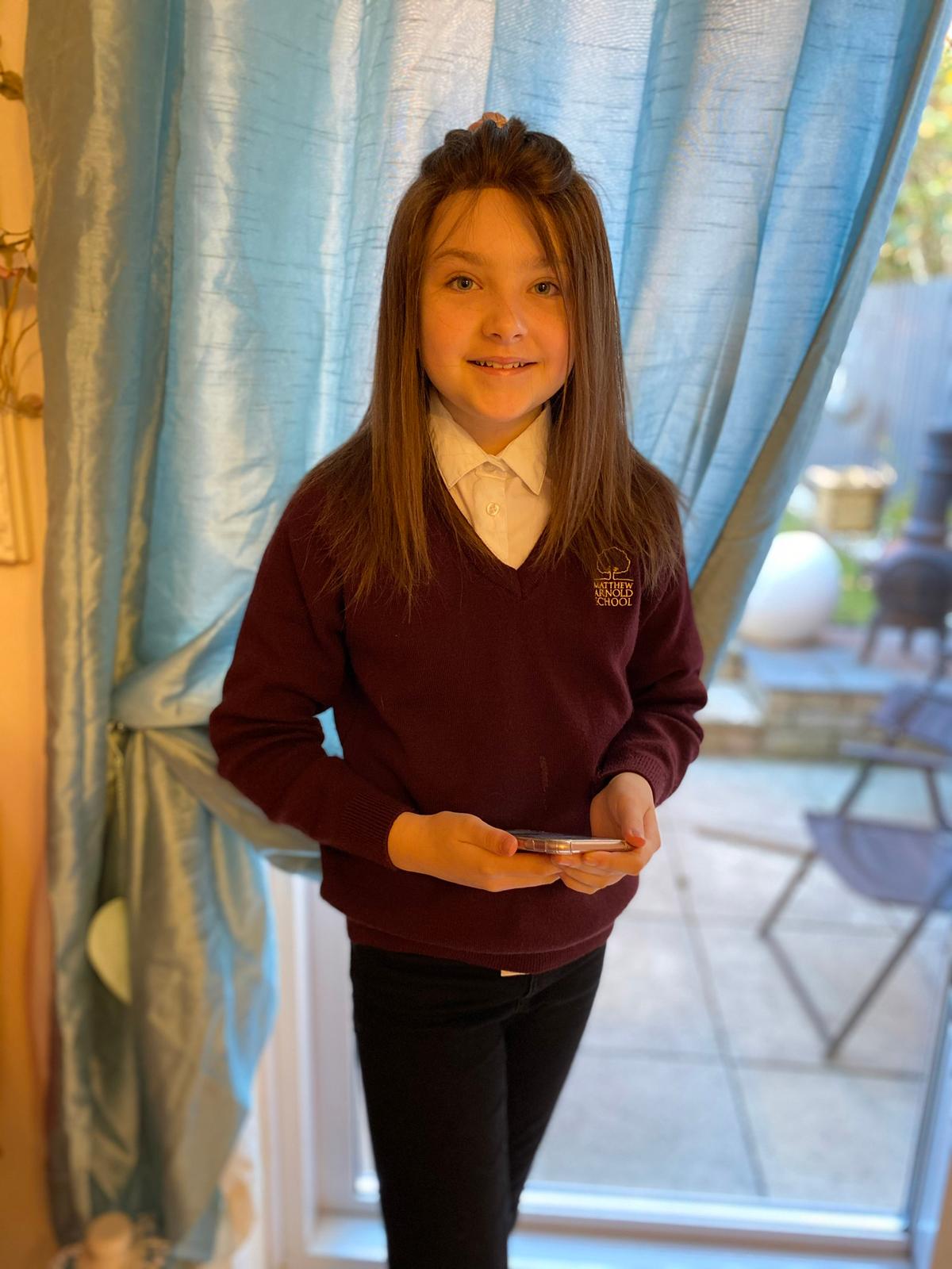 Lola wearing a wig gifted from the Little Princess Trust. (Caters News)
