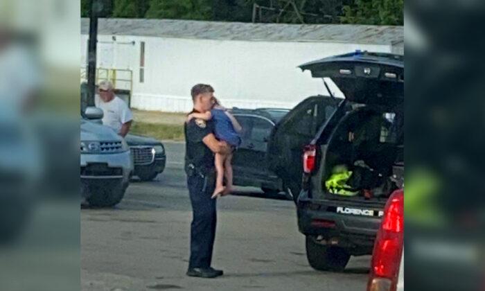 Photo of Alabama Police Officer Comforting Child After Machete Attack Goes Viral
