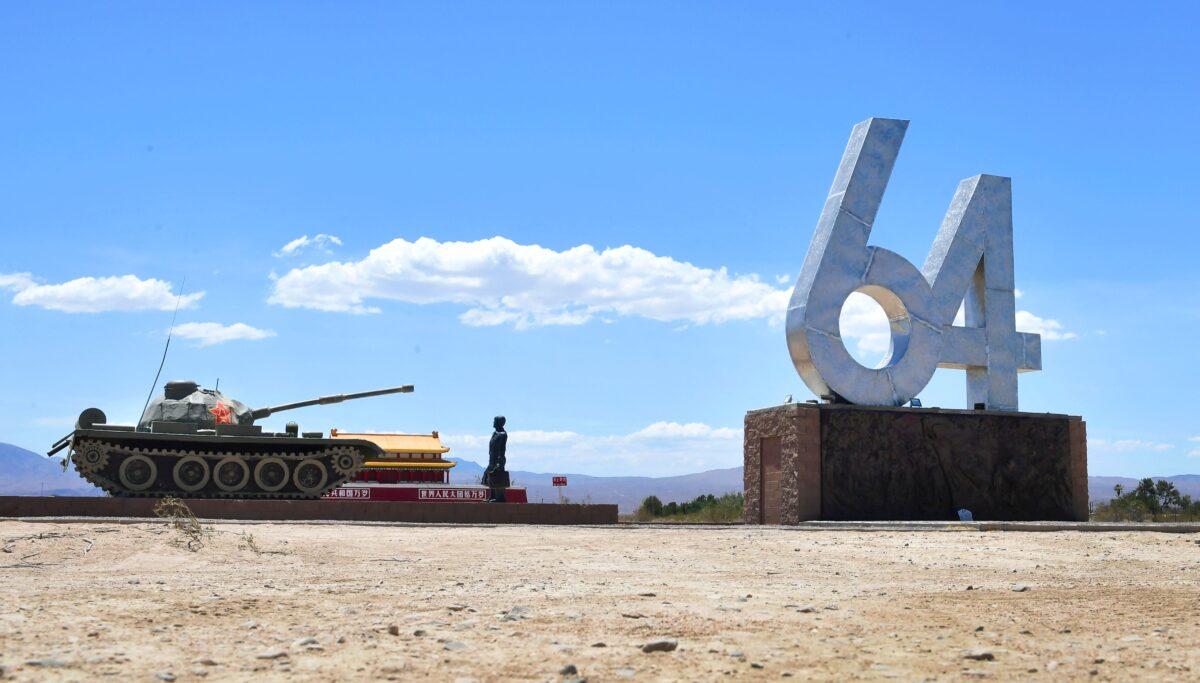 A life-size sculpture of "Tank Man" stands beside the numbers "6" and "4," representing June 4, and a miniature sculpture of Tiananmen Rostrum, on display at Liberty Sculpture Park in the Mojave desert town of Yermo, Calif., on June 1, 2021. (Frederic J. Brown/AFP via Getty Images)