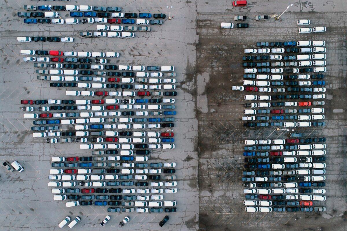 Mid-sized pickup trucks and full-size vans are seen in a parking lot outside a General Motors assembly plant where they are produced in Wentzville, Miss., on March 24, 2021. (Jeff Roberson/File/AP Photo)