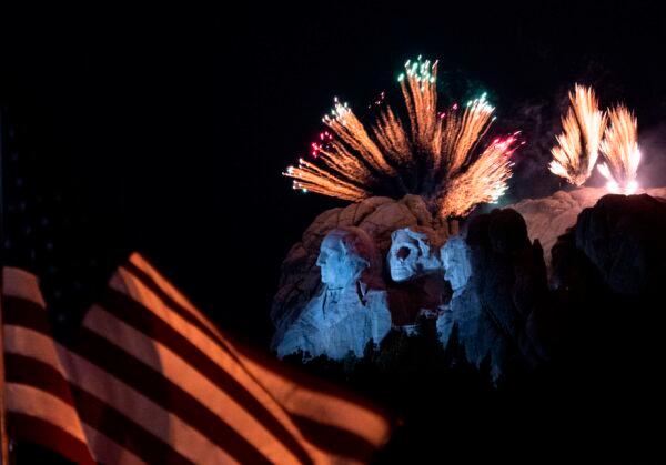 A U.S. flag flies as fireworks explode above the Mount Rushmore National Monument during an Independence Day event in Keystone, S.D., on July 3, 2020. (Andrew Caballero-Reynolds/AFP via Getty Images)