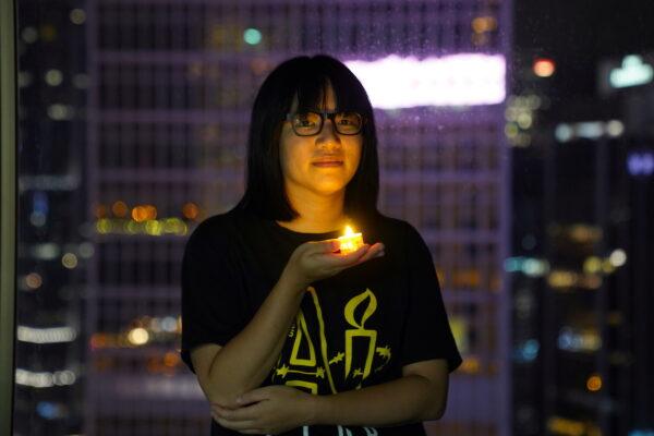 Chow Hang Tung, Vice-chairwoman of Hong Kong Alliance in Support of Patriotic Democratic Movements of China, poses with a candle ahead of the 32nd anniversary of the massacre of pro-democracy demonstrators at Beijing's Tiananmen Square in 1989, in Hong Kong, on June 3, 2021. (Lam Yik/Reuters)