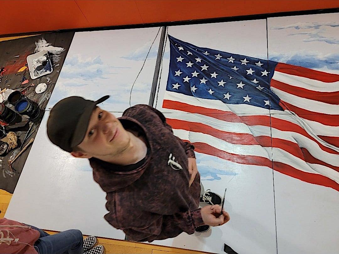 Hunter Delsite and his huge American flag mural. (Courtesy of <a href="https://www.facebook.com/BrendaRaub">Brenda Raub</a>)