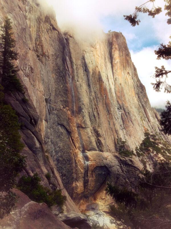 Nearly dry in this October picture, Yosemite Falls is a granite monolith that extends dreamily into the clouds.