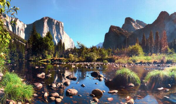 El Capitan and Bridalveil Fall tower majestically above the Merced River in the heart of Yosemite Valley.