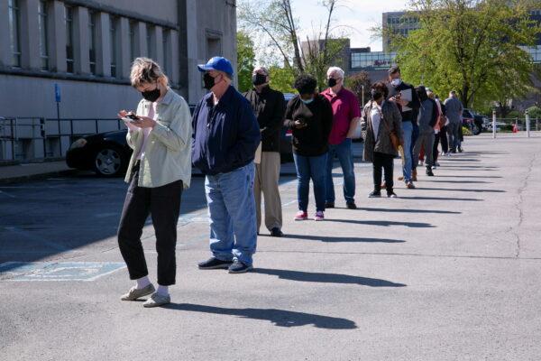 People line up outside a newly reopened career center for in-person appointments in Louisville, on April 15, 2021. (Amira Karaoud/Reuters)