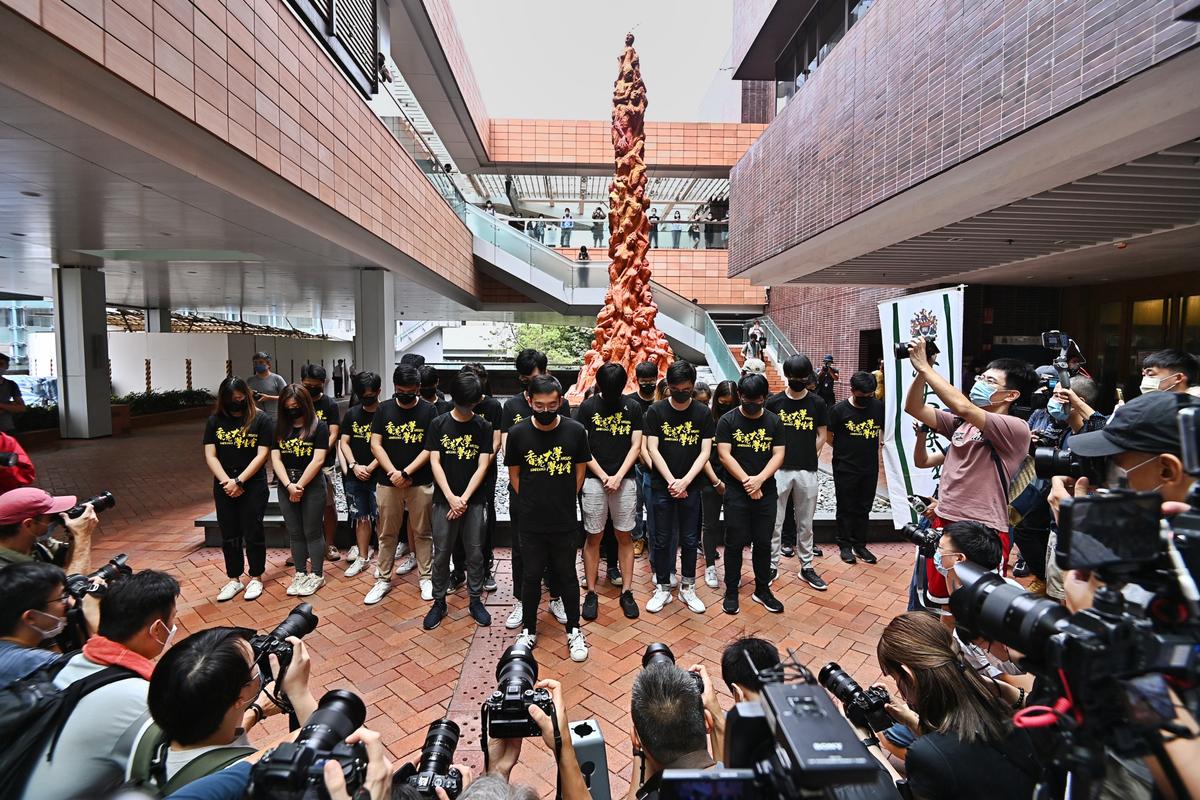 Students of the Hong Kong University Students' Union hold a moment of silence before the Pillar of Shame in Hong Kong on June 4, 2021. This is the last time the “Pillar of Shame” will be displayed at HKU on the June 4th commemoration. (Sung Pi-lung/The Epoch Times)