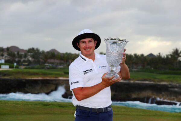 Joel Dahmen poses with the trophy after putting in to win on the 18th green during the final round of the Corales Puntacana Resort & Club Championship in Punta Cana, on March 28, 2021. (Kevin C. Cox/Getty Images)