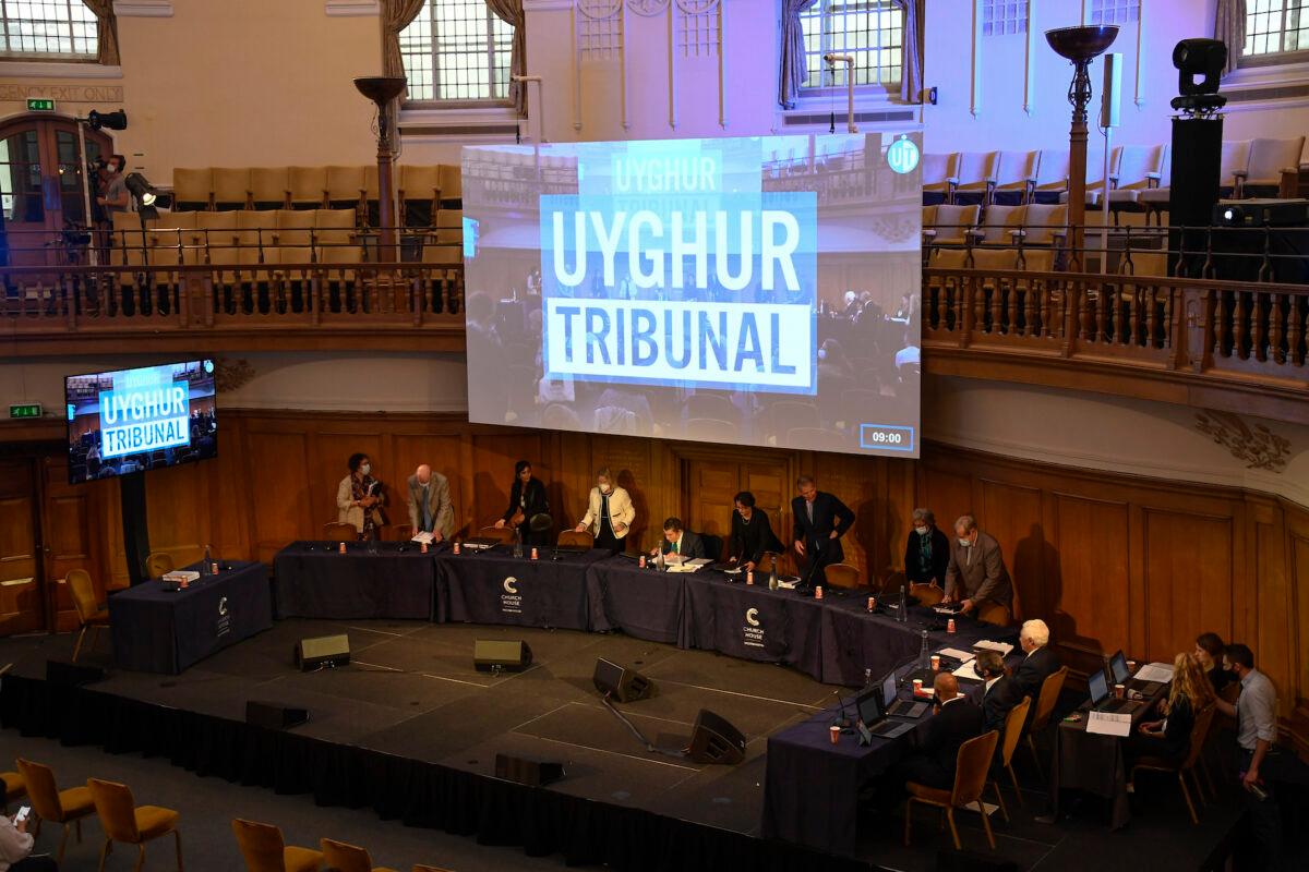 Members of the panel of the independent Uyghur Tribunal take their seats for the first session of the hearings at Church House in London on June 4, 2021. (Alberto Pezzali/AP Photo)