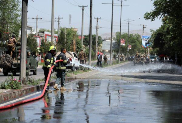 Afghan firefighters spray water at the scene of a roadside bomb explosion in Kabul, Afghanistan, on June 6, 2021. (Rahmat Gul/AP Photo)