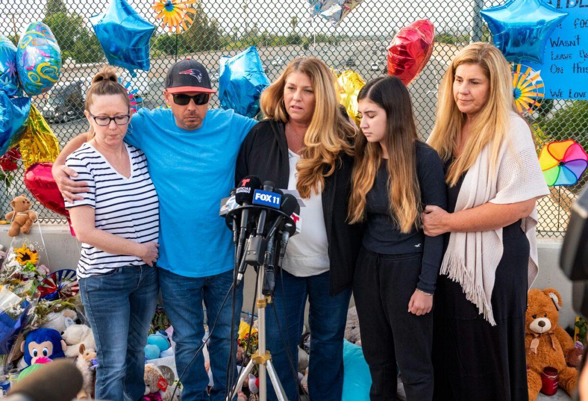 Family members of 6-year-old Aiden Leos stand at a makeshift memorial on the Walnut Avenue overpass at the 55 Freeway in Orange, to announce that the reward for information leading to the suspects in the road-rage shooting death of Leos, Calif., on May 25, 2021. (Leonard Ortiz/File/The Orange County Register via AP)