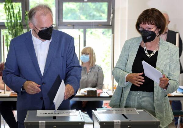 Saxony-Anhalt State Premier Reiner Haseloff of the Christian Democratic party (CDU) and his wife Gabriele cast their votes for the federal state election of Saxony-Anhalt, in Lutherstadt Wittenberg, Germany, on June 6, 2021. (Christian Mang/Reuters)