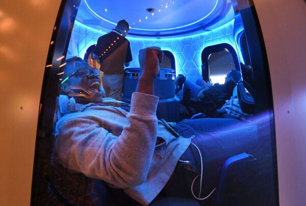 Participants enjoy the Blue Origin Space Simulator during the Amazon MARS conference on robotics and artificial intelligence at the Aria Hotel in Las Vegas on June 5, 2019. (Mark Ralston/AFP via Getty Images)
