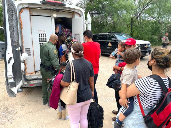 A group of Venezuelans are picked up by Border Patrol after illegally crossing the Rio Grande from Mexico into Del Rio, Texas, on June 3, 2021. (Charlotte Cuthbertson/The Epoch Times)
