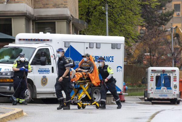 Paramedics take a patient to the emergency department at Sunnybrook Hospital in Toronto on May 4, 2021. (The Canadian Press/Frank Gunn)