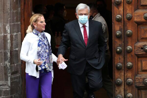 Mexican President Andres Manuel Lopez Obrador (R) and first lady Beatriz Gutierrez walk away after voting in Mexico City, on June 6, 2021. (Marco Ugarte/AP Photo)