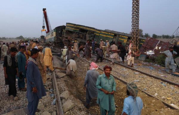 Railway workers rebuild the track at the track at the site of a train collision in the Ghotki district, southern Pakistan, on June 7, 2021. (Fareed Khan/AP Photo)