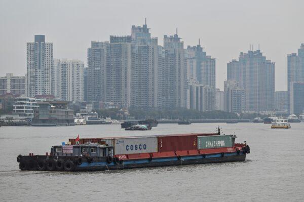 A vessel transports containers along the Huangpu River in Shanghai on March 5, 2021. (Hector Retamal/AFP via Getty Images)