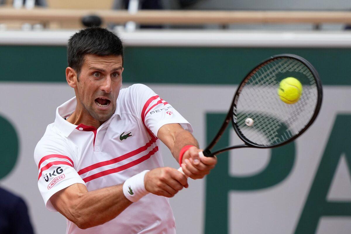 Serbia's Novak Djokovic plays a return to Italy's Lorenzo Musetti during their fourth-round match on day 9, of the French Open tennis tournament at Roland Garros in Paris, France, on, June 7, 2021. (Michel Euler/AP Photo)