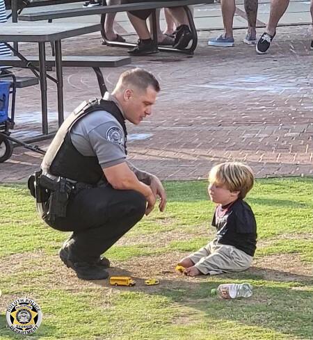 Officer Rolf Seiferheld talking to Harrison Humphries during the Food Truck Friday event in downtown Duluth on May 21. (Courtesy of <a href="https://www.duluthga.net/">Duluth Police Department</a>)