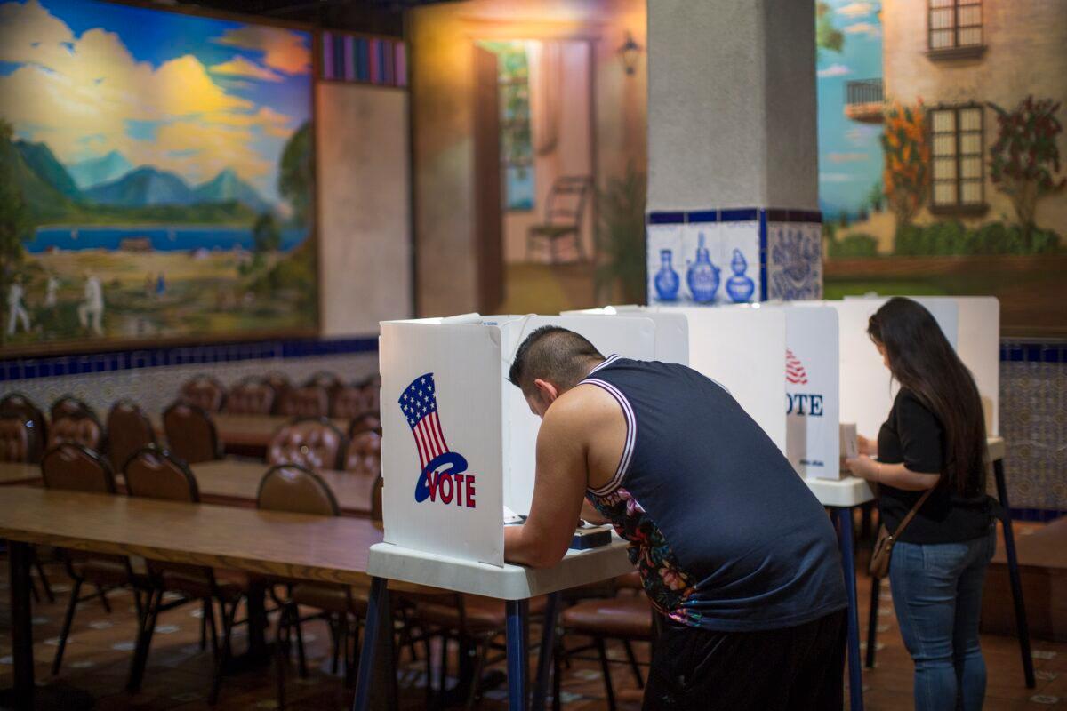Latinos vote at a polling station in El Gallo Restaurant in Los Angeles, Calif., on Nov. 8, 2016. (David McNew/Getty Images)