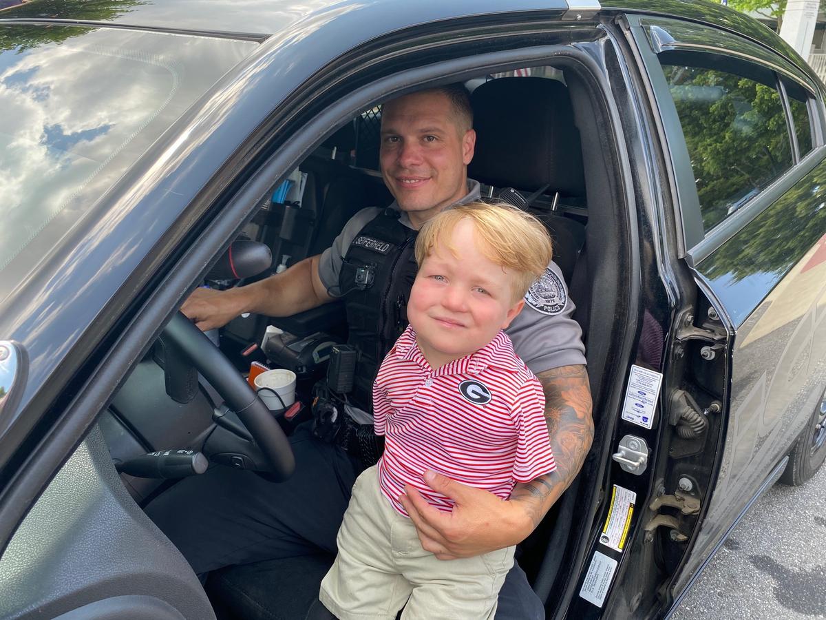 Officer Rolf Seiferheld of the Duluth Police Department with Harrison Humphries. (Courtesy of <a href="https://www.duluthga.net/">Duluth Police Department</a>)