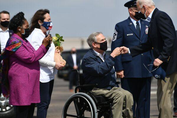 President Joe Biden (R) greets Texas Governor Greg Abbott and his wife Cecilia Abbott (2nd L) at Ellington Field Joint Reserve Base in Houston, Texas, on Feb. 26, 2021. Also welcoming the president is Rep. Sheila Jackson Lee (L). (Mandel Ngan/AFP via Getty Images)