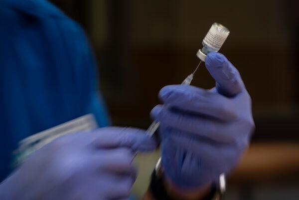 A nursing student prepares doses of the Pfizer COVID-19 vaccine for use in a vaccination clinic hosted by Odessa College in Odessa, Texas, on June 3, 2021. (Eli Hartman/Odessa American via AP)