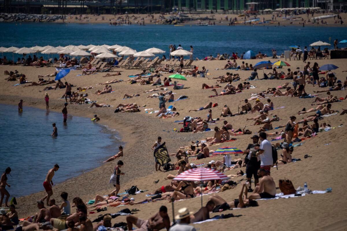 People sunbathe on the beach in Barcelona, Spain, Tuesday, on June 8, 2021. (Emilio Morenatti/AP Photo)