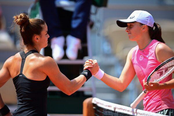 Greece's Maria Sakkari (L) and Poland's Iga Swiatek shake hands at the end of their women's singles quarter-final tennis match on Day 11 of the 2021 French Open tennis tournament in Paris on June 9, 2021. (Martin Bureau/AFP via Getty Images)