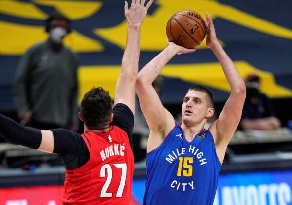 Denver Nuggets center Nikola Jokic (15) shoots against Portland Trail Blazers center Jusuf Nurkic (27) during the first half of Game 5 of a first-round NBA basketball playoff series in Denver, Colo., on June 1, 2021. (Jack Dempsey/AP Photo)