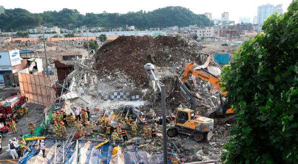 Firefighters search for survivors following a collapsed building in Gwangju, South Korea, on June 9, 2021. (Chung Hoi-sung/Yonhap via AP)
