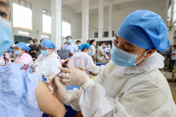 This photo taken on June 3, 2021 shows a health worker administering the Sinovac COVID-19 coronavirus vaccine to a resident in Rongan, in China's southern Guangxi region. (STR/AFP via Getty Images)