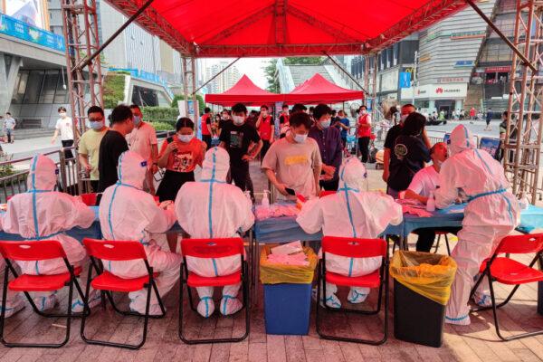People receive nucleic acid tests for the COVID-19 in Shenzhen, Guangdong Province, on June 6, 2021. (STR/AFP via Getty Images)
