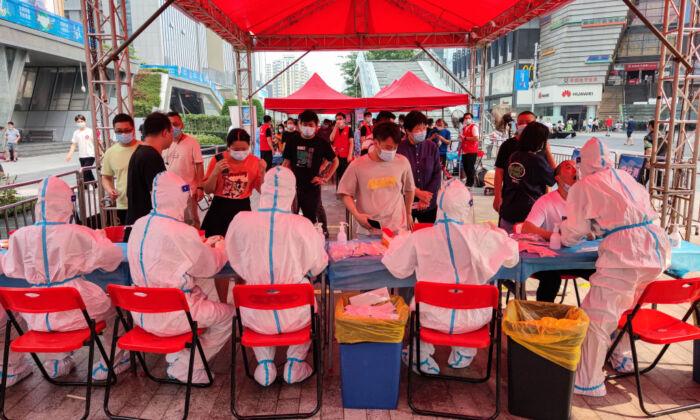 People receive nucleic acid tests for the COVID-19 in Shenzhen, Guangdong Province, China, on June 6, 2021. (STR/AFP via Getty Images)
