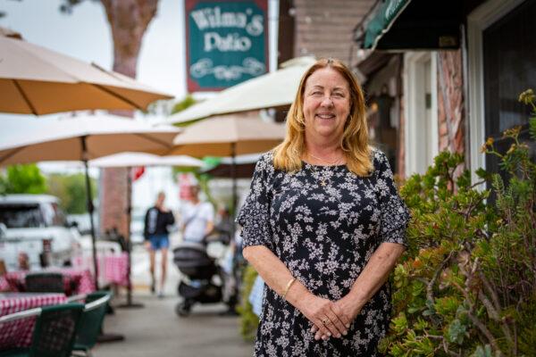 Owner Sheri Drewry stands in front of Wilma's Patio Restaurant in Newport Beach, Calif., on June 3, 2021. (John Fredricks/The Epoch Times)