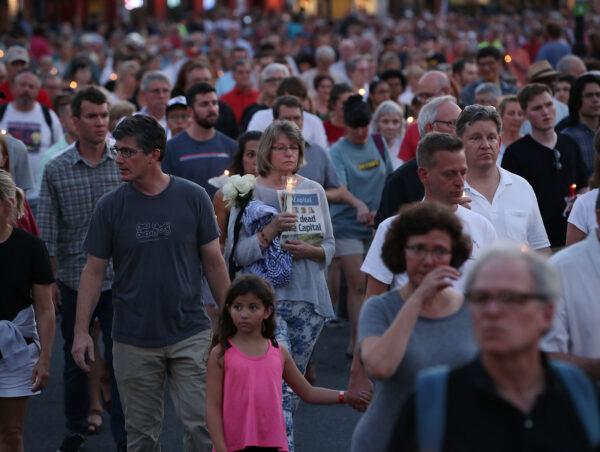 People walk down Main St. during a candlelight vigil to honor the 5 people were shot and killed at the Capital Gazette newspaper the day before, in Annapolis, Md., on June 29, 2018. (Mark Wilson/Getty Images)