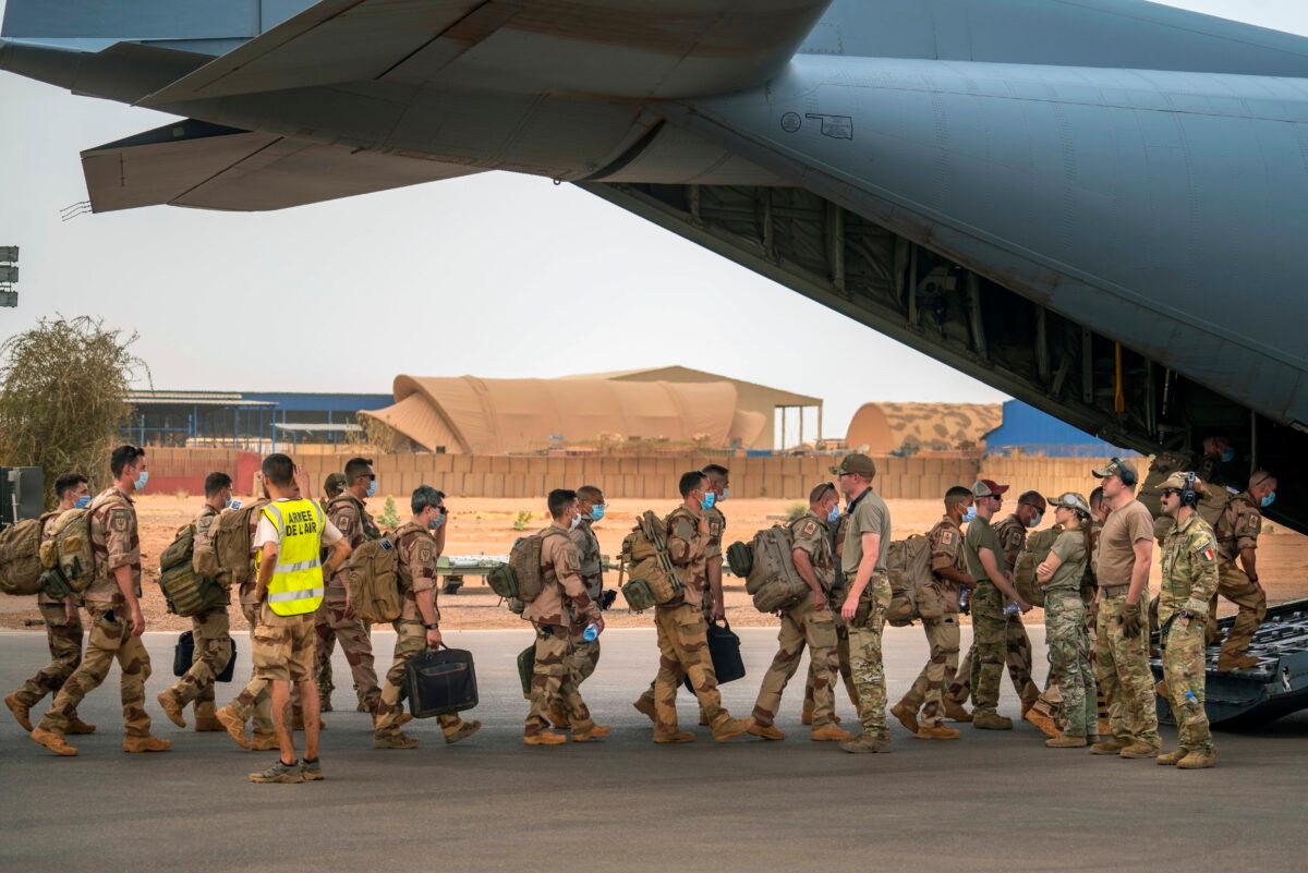 French Barkhane force soldiers who wrapped up a four-month tour of duty in the Sahel board a US Air Force C130 transport plane, leave their base in Gao, Mali on June 9, 2021. (Jerome Delay/AP Photo)