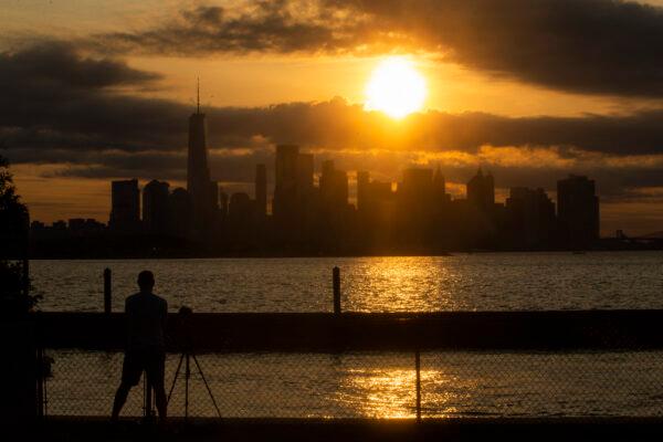 The New York skyline is seen as the moon partially covers the sun during a partial solar eclipse seen from Jersey City, N.J., on June 10, 2021. (Kena Betancur/AFP via Getty Images)