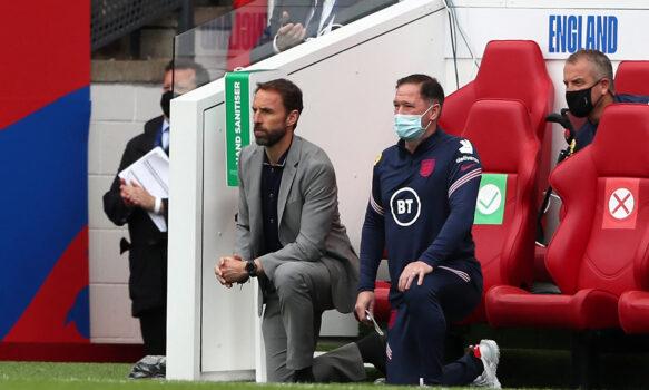 England's manager Gareth Southgate (L) and Steve Holland, Assistant Coach of England, 'take a knee' ahead of the international friendly football match between England and Romania at the Riverside Stadium in Middlesbrough, north-east England on June 6, 2021. (Scott Heppell/Pool/AFP via Getty Images)