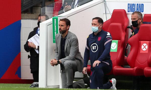 England's manager Gareth Southgate (L) and Steve Holland, assistant coach of England, take a knee ahead of the international friendly football match between England and Romania at the Riverside Stadium in Middlesbrough, northeast England, on June 6, 2021. (Scott Heppell/Pool/AFP via Getty Images)