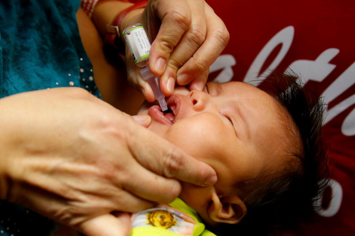 A baby gets an oral anti-polio vaccine during the launch of a campaign to end the resurgence of polio after health authorities confirmed a polio case in the country in Quezon city, Philippines, on Sept. 20, 2019. (Bullit Marquez/File/AP Photo)