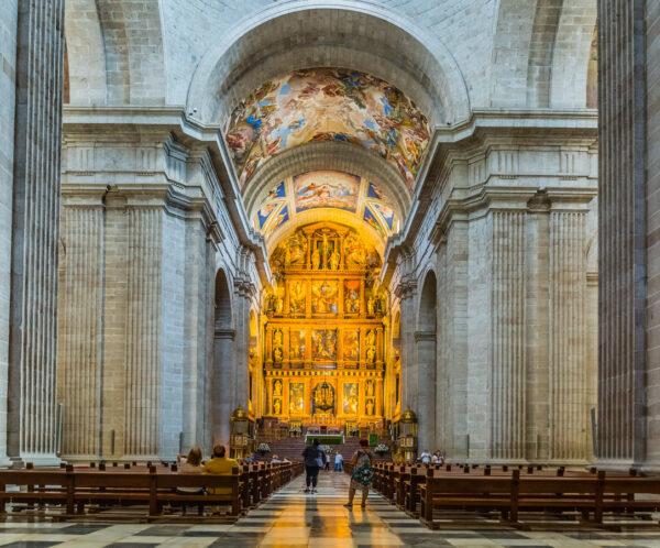 At the heart of the complex lies the basilica. The austere, monotone-colored nave provides a striking contrast to emphasize the brilliant high altar and ceiling frescoes depicting divine realms. (John Silver/Shutterstock)