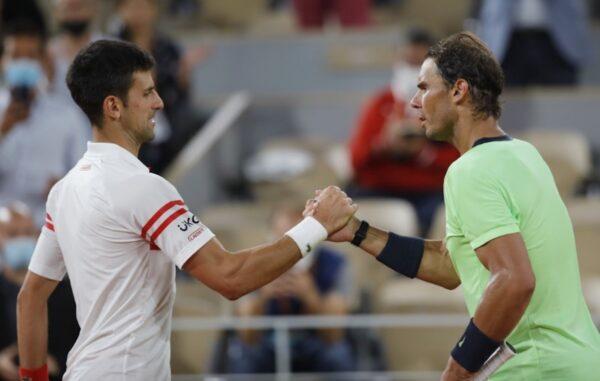 Serbia's Novak Djokovic shakes hands with Spain's Rafael Nadal after winning their semifinal match of the French Open tennis tournament at the Roland Garros stadium in Paris on June 11, 2021. (Sarah Meyssonnier/Reuters)