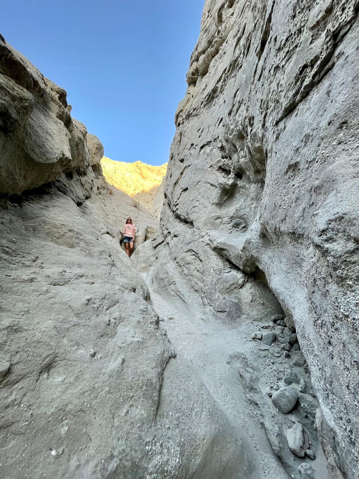 The author climbs through a slot canyon. (Janna Graber)