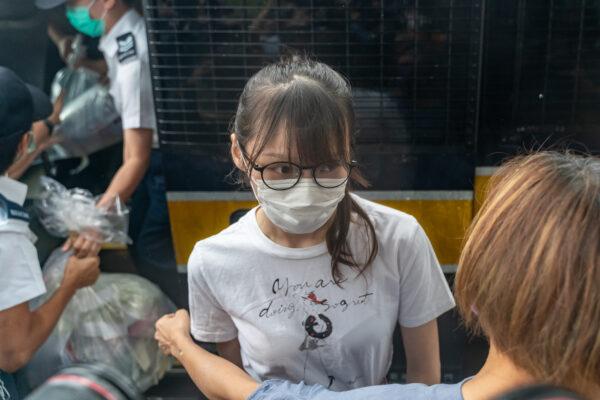 Hong Kong pro-democracy activist Agnes Chow steps out of a Hong Kong Correctional Services vehicle after being released from the Tai Lam Correctional Institution in Tuen Mun district in Hong Kong on June 12, 2021. (Anthony Kwan/Getty Images)