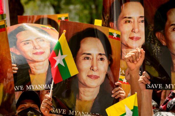  A protester holds a sign with an image of detained civilian leader Aung San Suu Kyi as they prepare to face off against security forces during a demonstration against the military coup in Yangon, Burma, on March 5, 2021. (AFP via Getty Images)