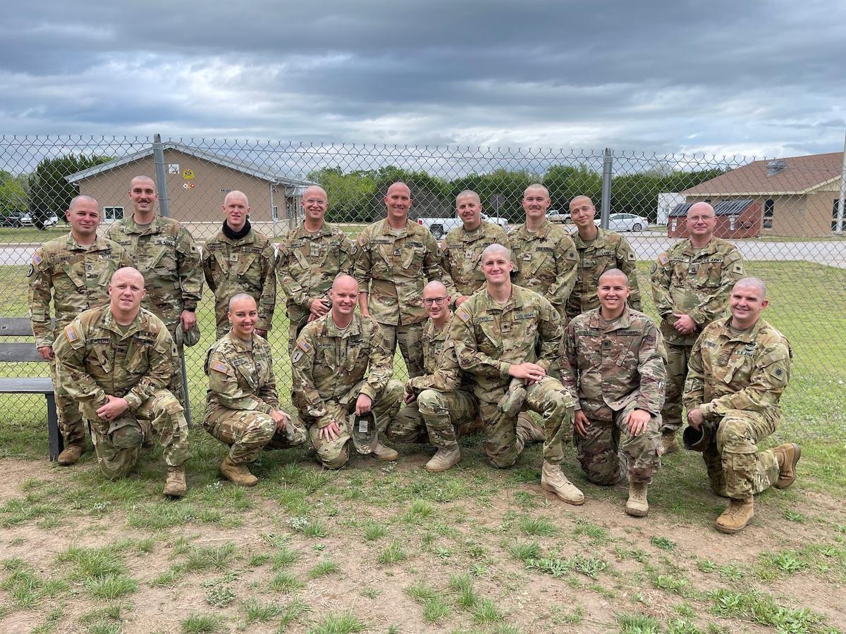 Soldiers from 1st Battalion, 171st Aviation Regiment shaved their heads and posed for a picture at North Fort Hood, Texas. (Courtesy of 1st Lt. Luke Legrand/<a href="https://www.dvidshub.net/image/6639455/soldiers-shave-their-heads-support-battle-buddys-sister-who-recovering-cancer">U.S. Army National Guard</a>)